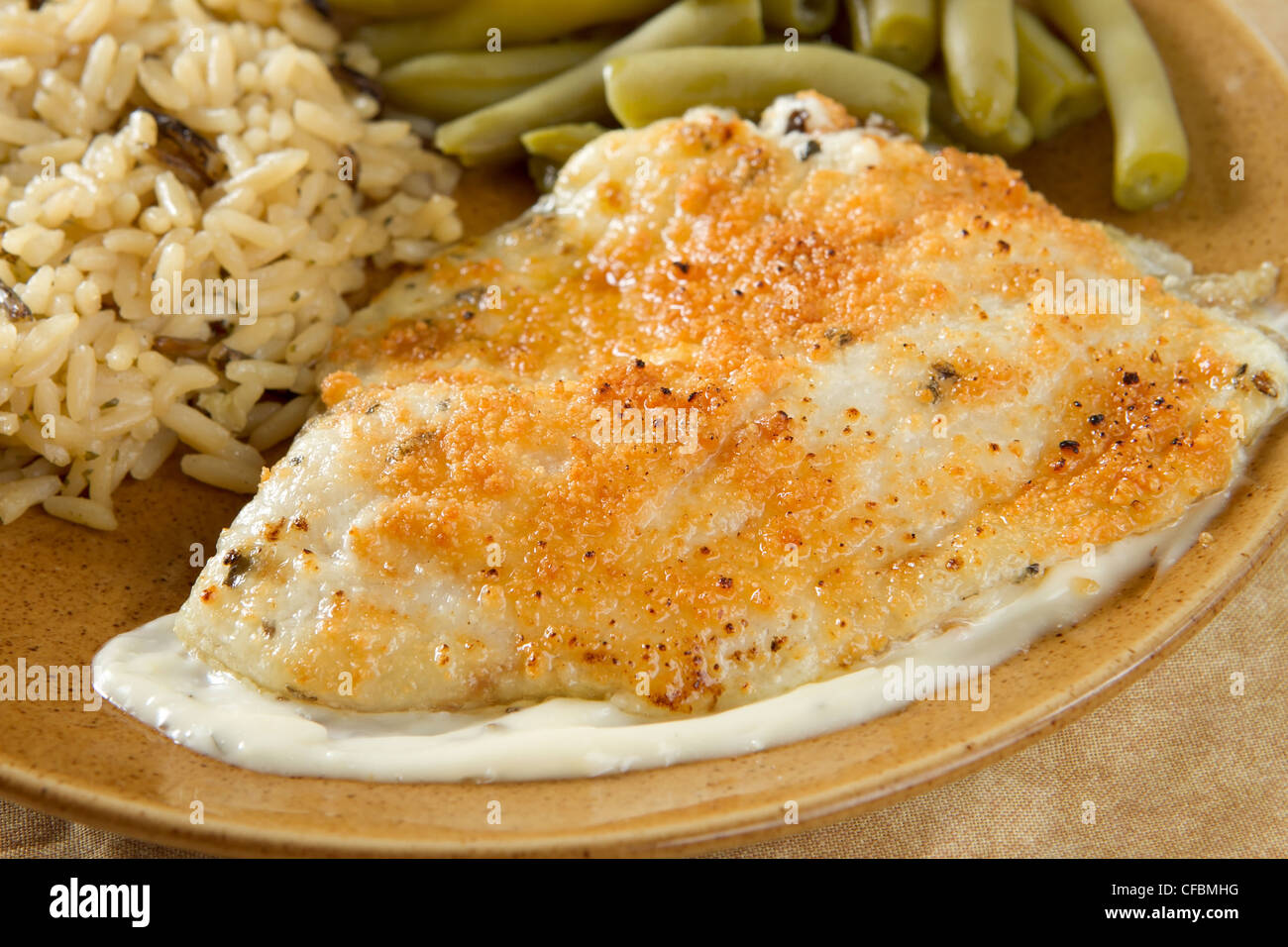tilapia with parmesan sauce, rice and green beans Stock Photo Alamy