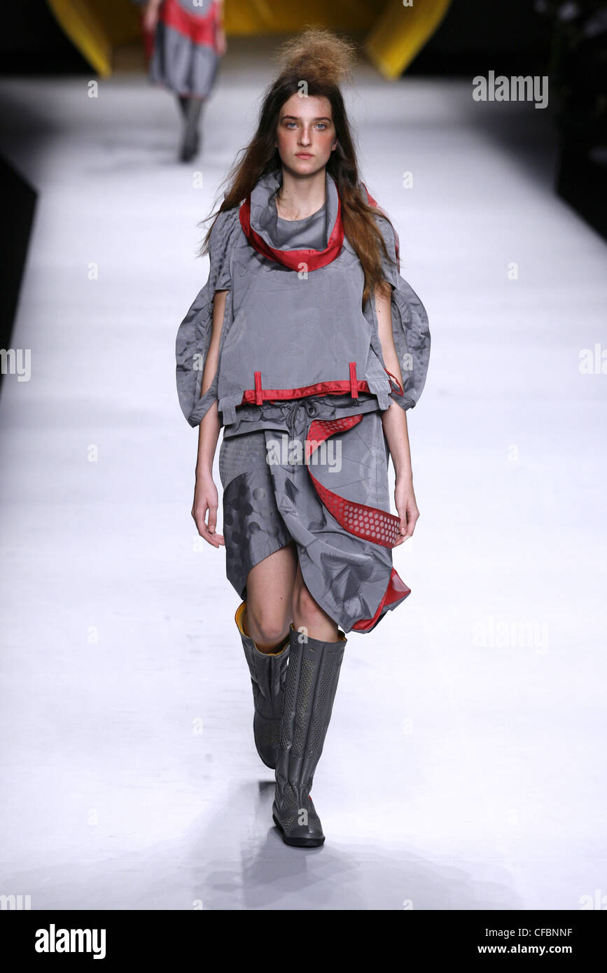 Issey Miyake Paris Ready to Wear Spring Summer Grey and red silk drape dress  with flat knee length boots Stock Photo - Alamy