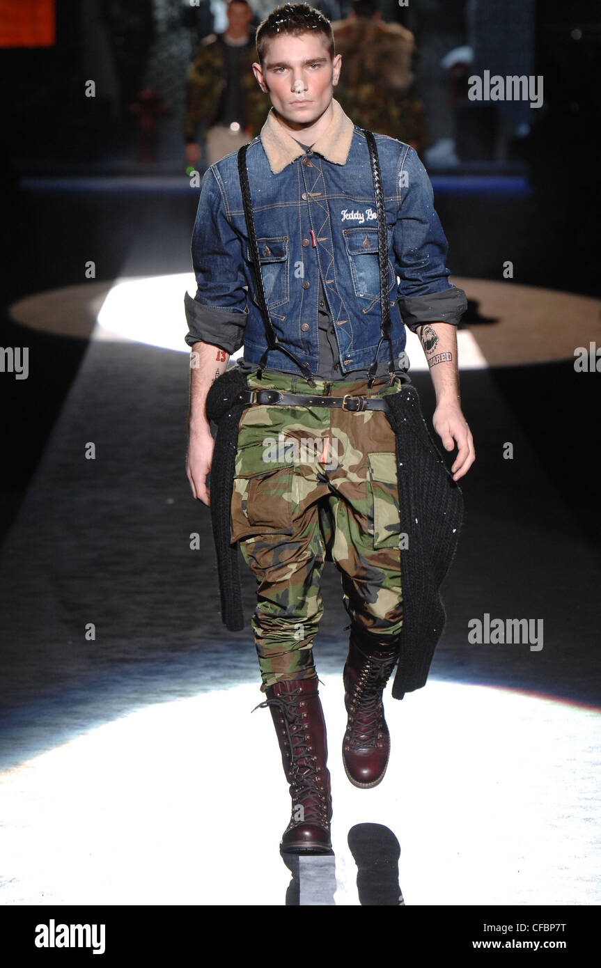 DSquared Milan Ready to Wear Autumn Winter Military Style: Tattooed male  wearing denim jacket , camouflage pants tucked into Stock Photo - Alamy