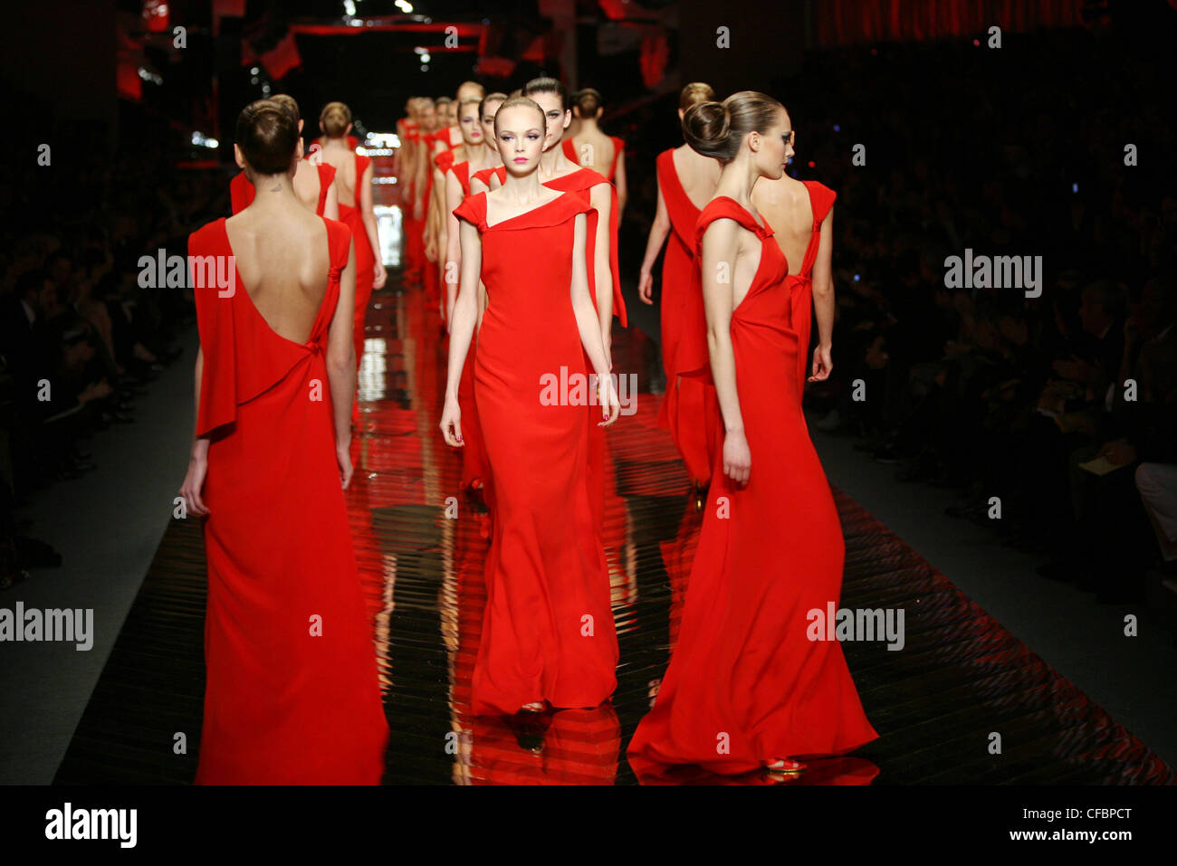 Valentino: Final Show and th Anniversary Paris Haute Couture Spring Summer  Group of females wearing identical long red dresses Stock Photo - Alamy