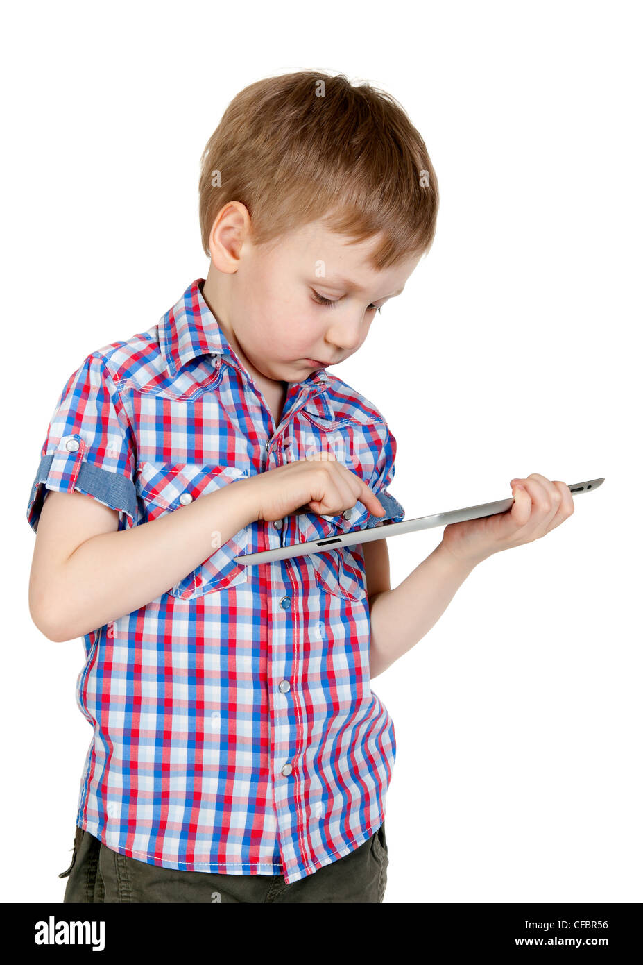 A boy in a plaid shirt with a tablet computer isolated on white ...