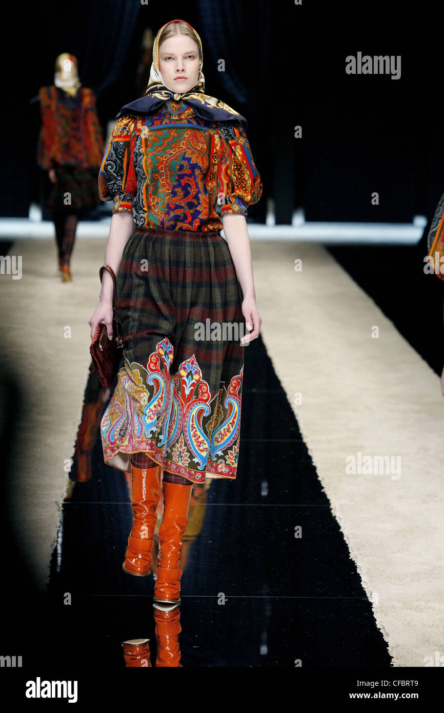 D&G Ready to Wear Autumn Winter  Granny Style and Paisley Print: headscarf, print blouse, checked full skirt, red patent knee Stock Photo