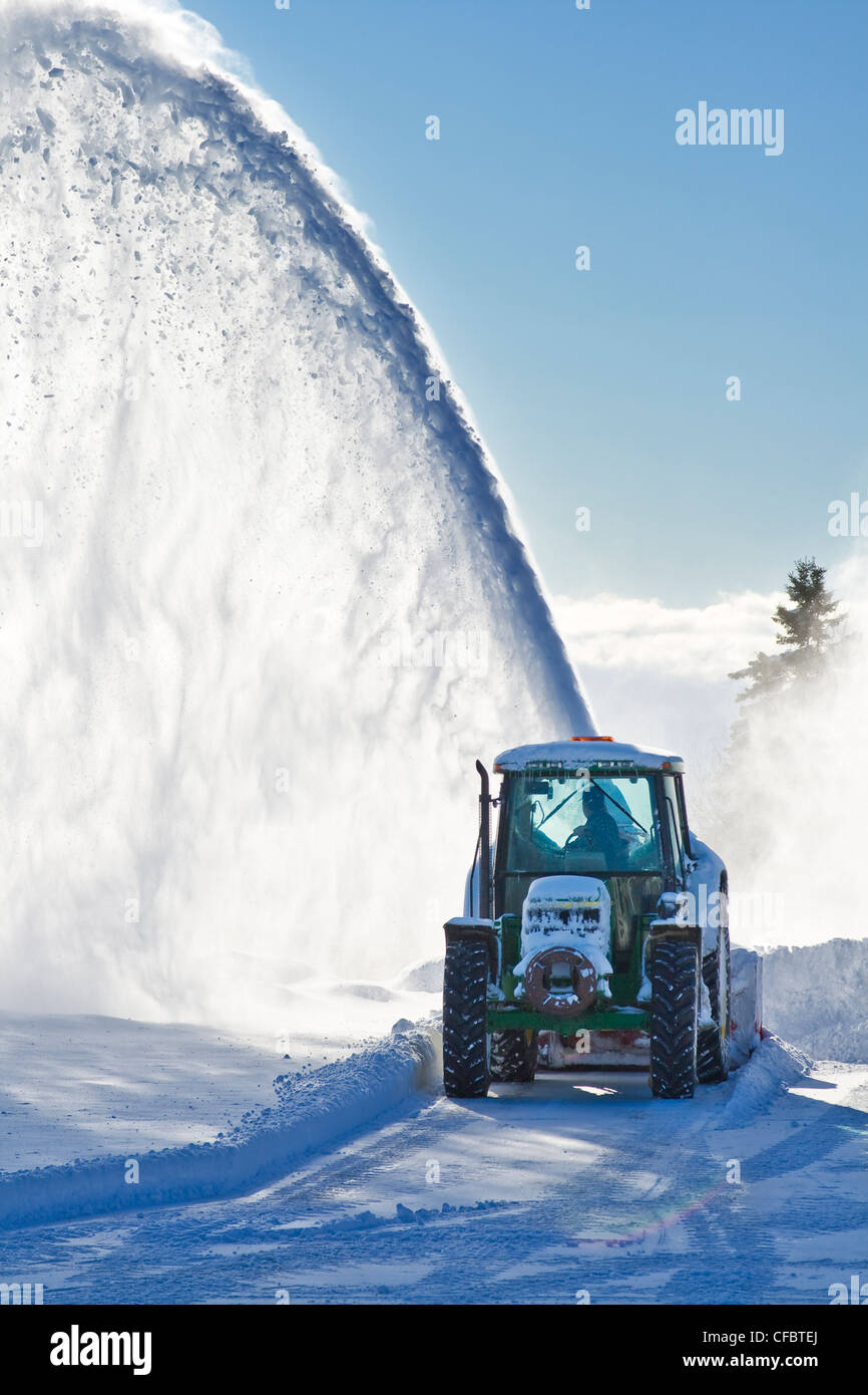 Snowblower throwing snow high and far away Stock Photo Alamy
