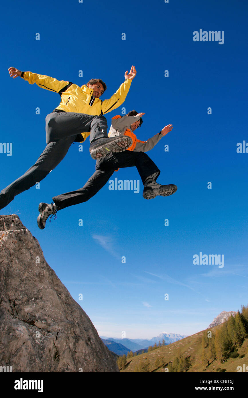 two, men, husbands, jump, rocks, cliffs, jump, emptiness, blue, sky