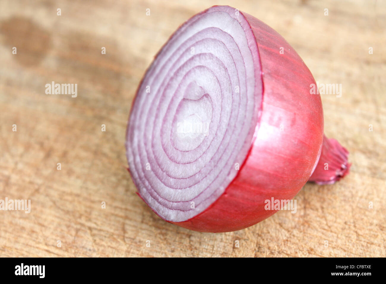 A sliced red onion on a wooden background Stock Photo