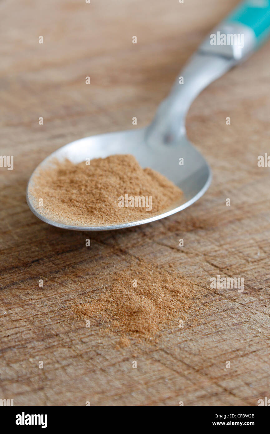 Cinnamon on a spoon on a bg Stock Photo