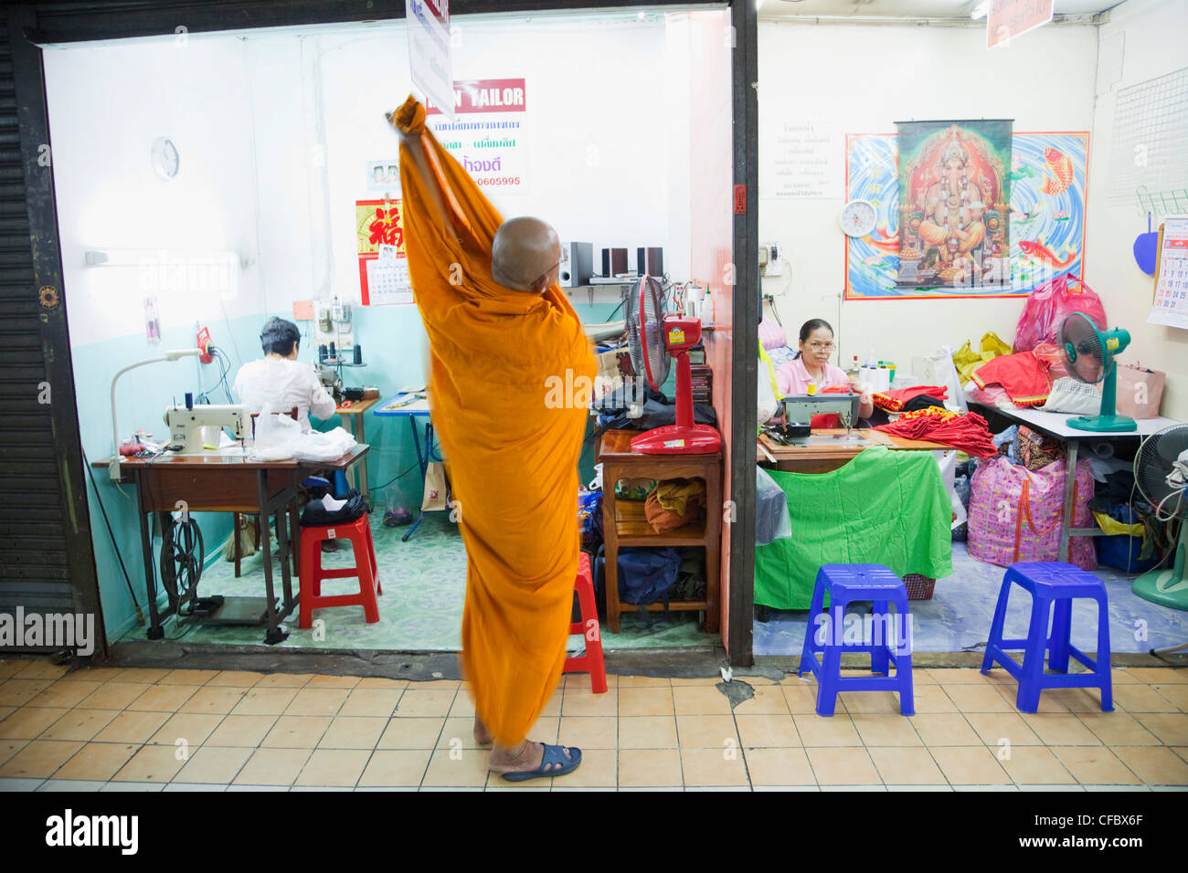Thailand, Bangkok, Monk Outside Tailor Shop Stock Photo