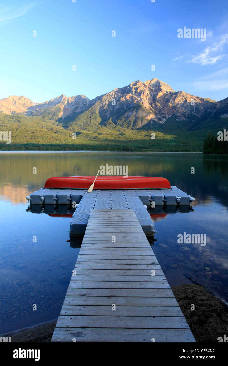 Red canoe on dock at Pyramid Lake with Pyramid mountain, Jasper