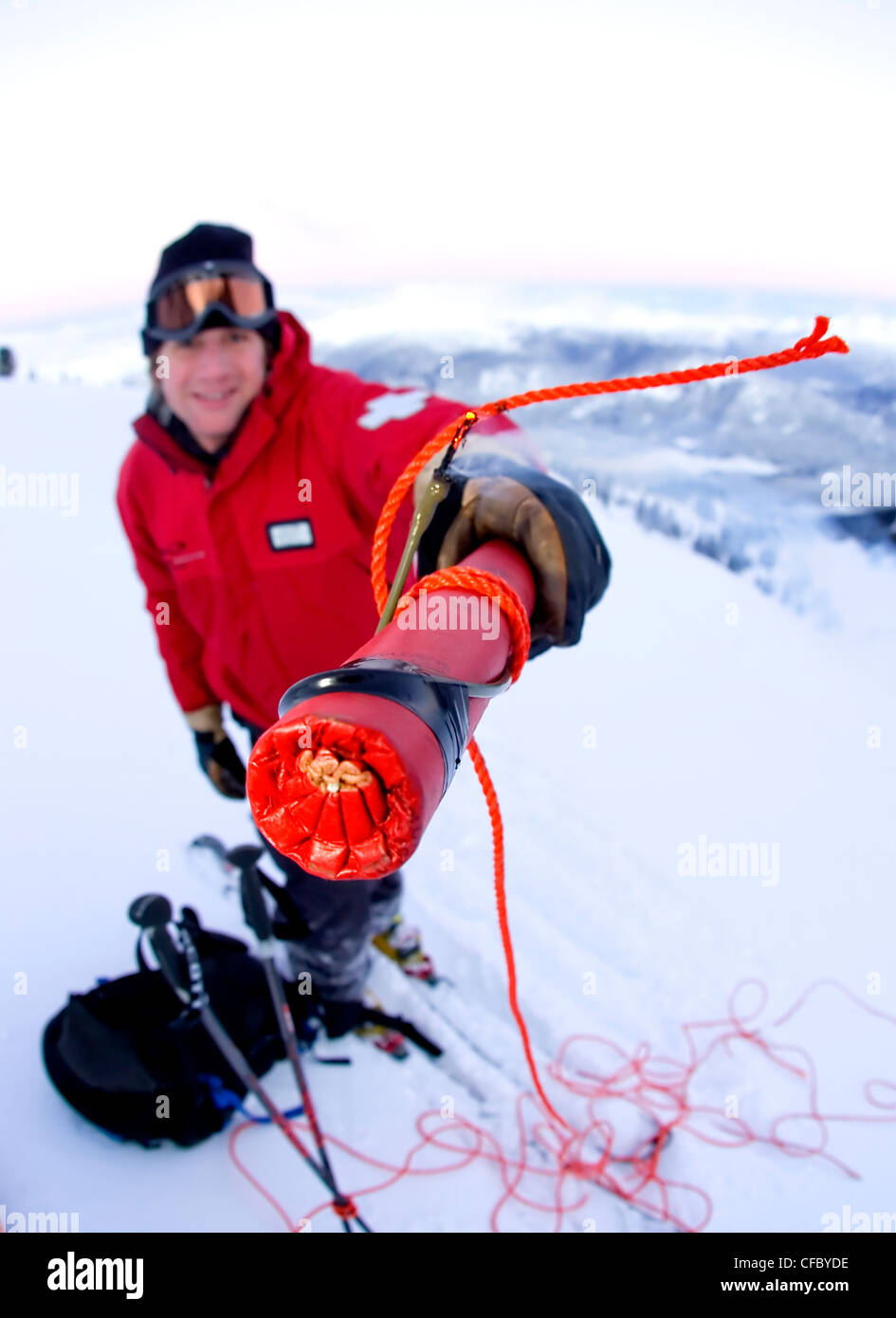 Man with explosives carrying out avalanche control, Blackcomb Mountain, Whistler, British Columbia, Canada Stock Photo