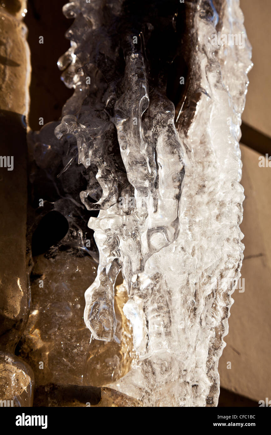 Ice formed from water dripping from a drain pipe in the harsh winter in