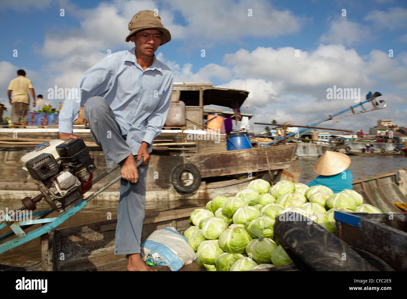 A traders steers his boat along the floating market at Cai Rang, (Can Tho) Vietnam Stock Photo