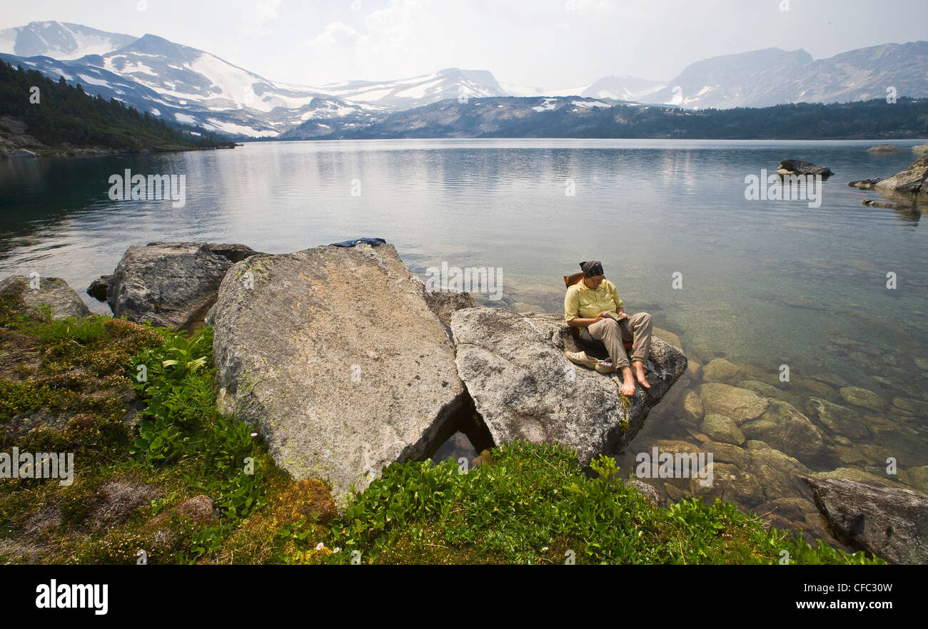 reading in the wilderness in the Charlotte Alplands within the Chilcotin region of British Columbia Canada Stock Photo