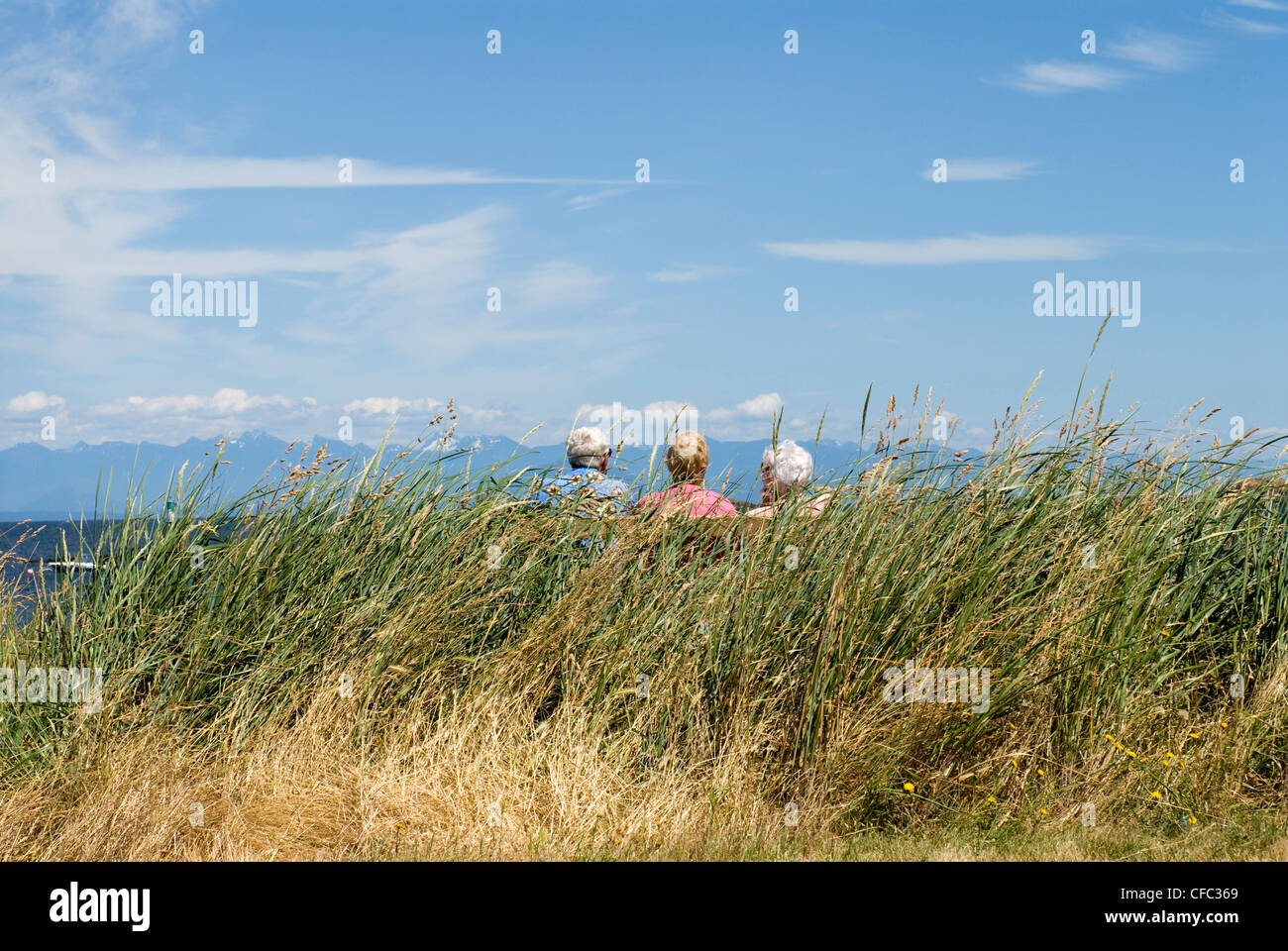 People sitting on a bench at Pipers Lagoon. Nanaimo, BC, Canada. Stock Photo