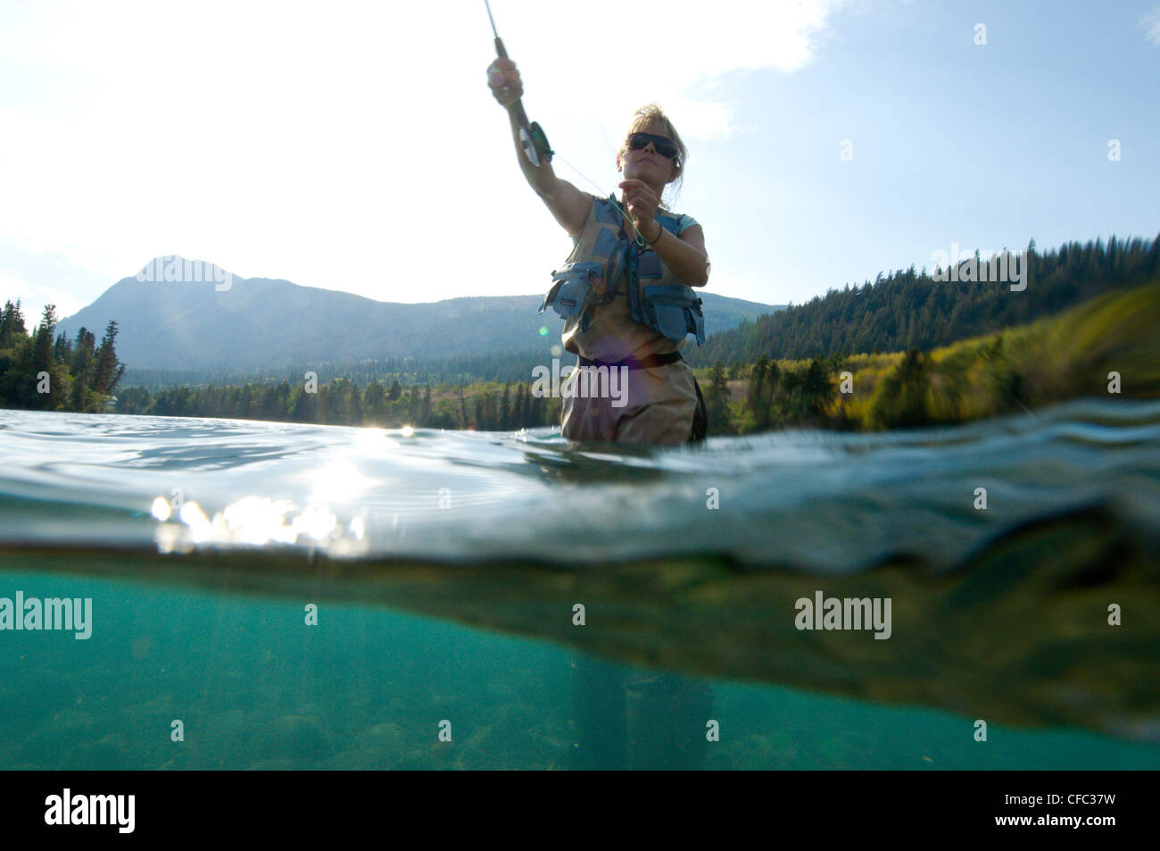 A young, attractive woman fly fishing on the Chilko River, British Columbia, Canada Stock Photo