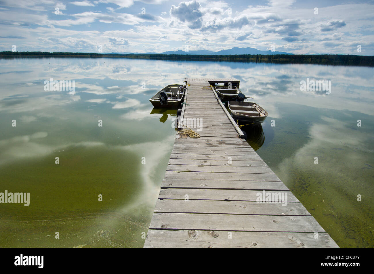 A dock and fishing boats on a summer day on the shores of Anahim Lake