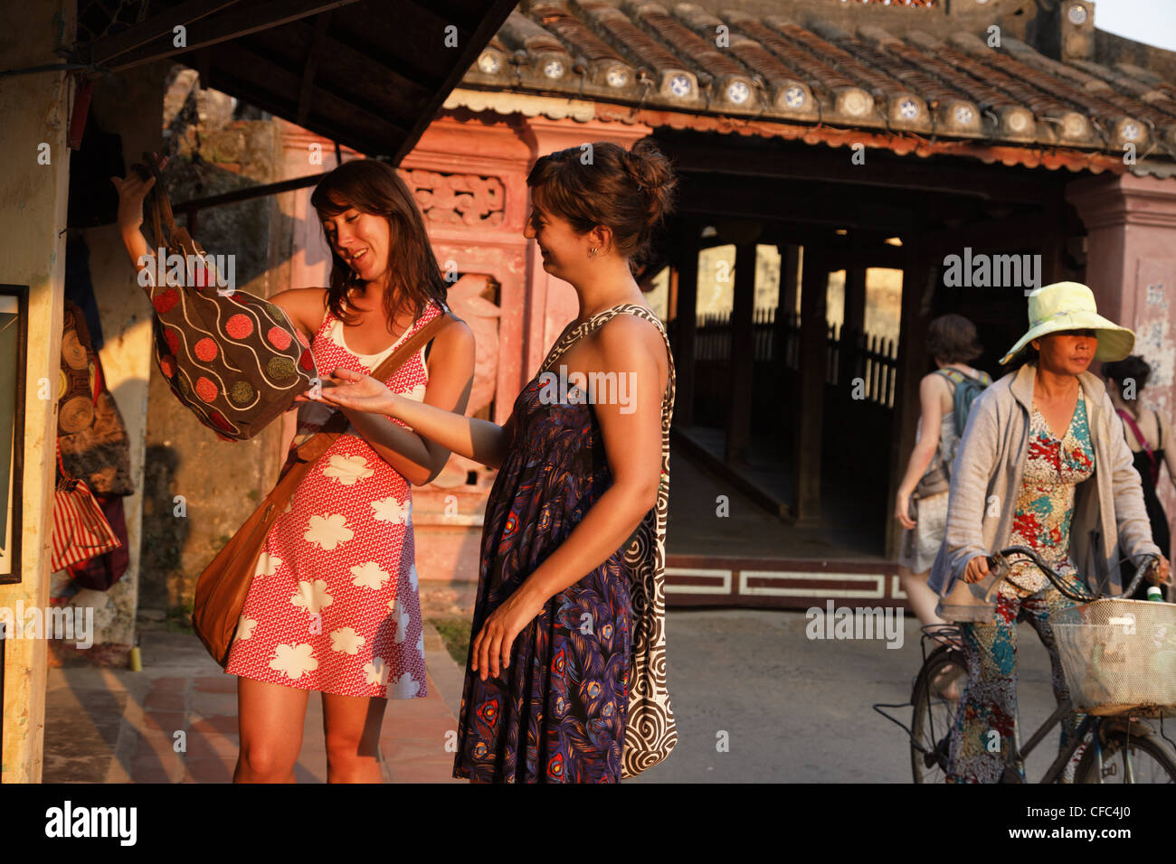 Two women shopping, Chua Cau, Japanese Bridge, Hoi An, Annam, Vietnam Stock Photo