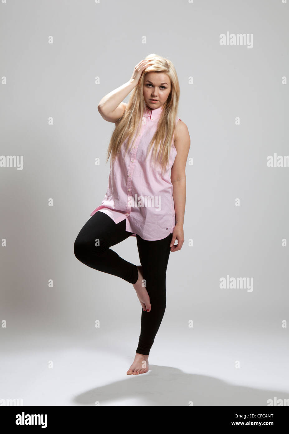 https://c8.alamy.com/comp/CFC4NT/full-length-colour-studio-portrait-female-wearing-pink-shirt-and-black-CFC4NT.jpg