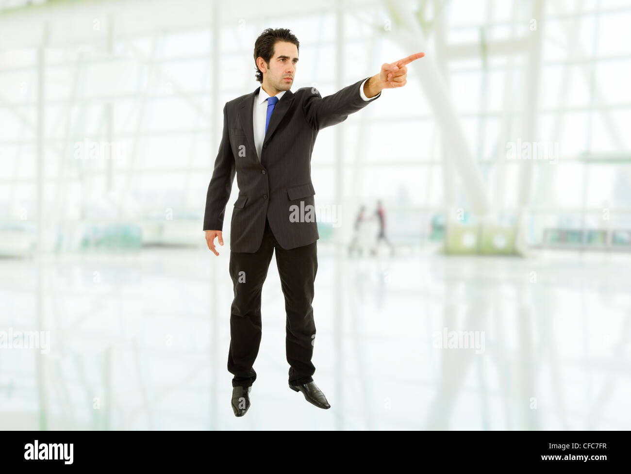 young business man in a suit pointing with his finger Stock Photo - Alamy