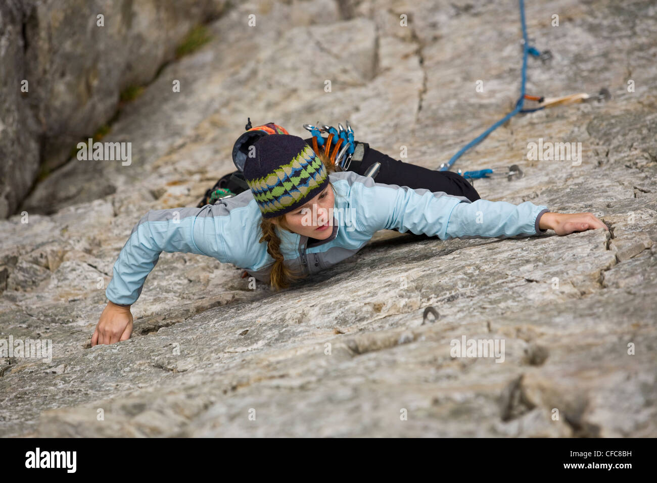 A young woman rockclimbing in Kamouraska, QC Stock Photo