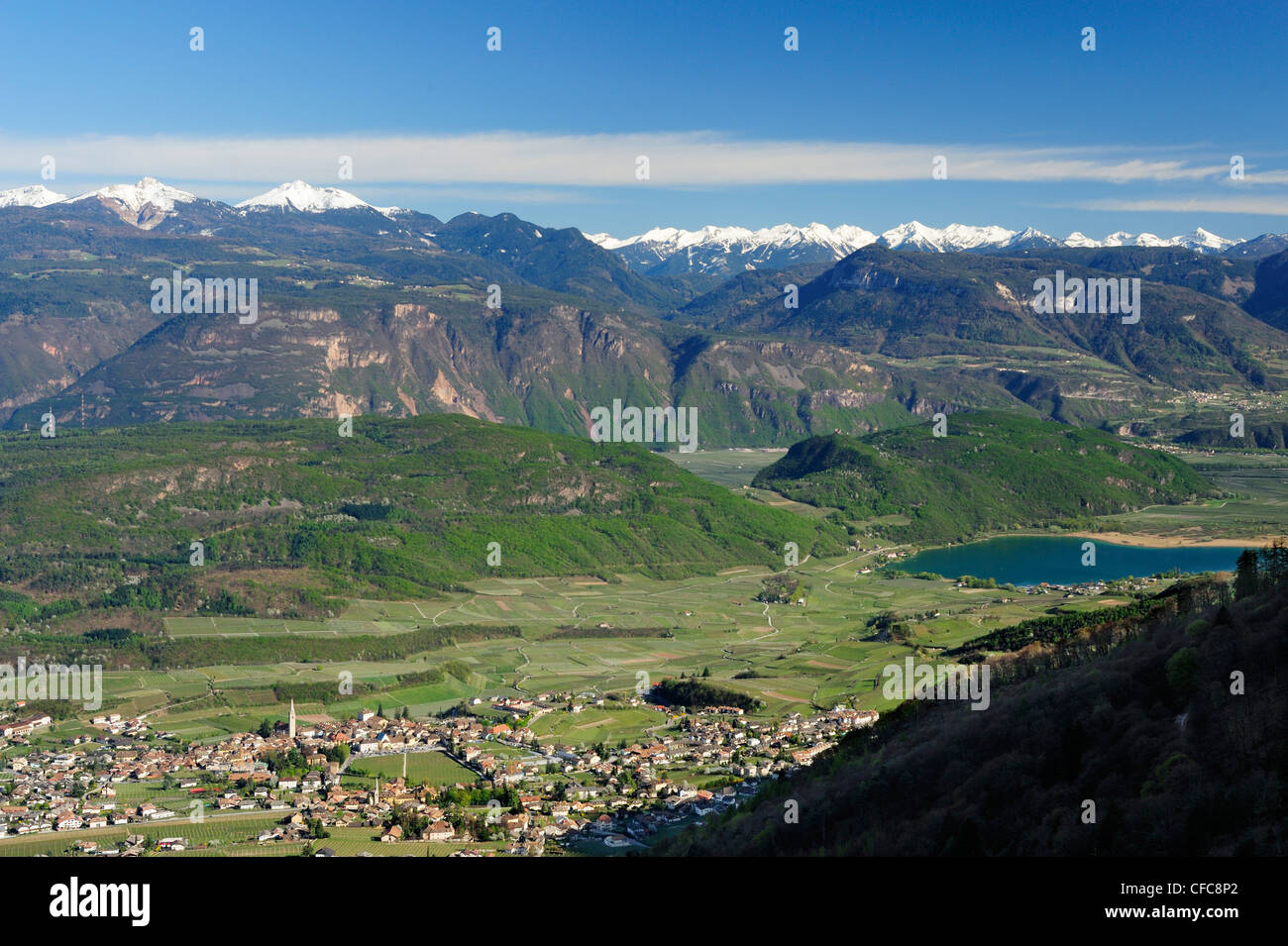 View to Kaltern and Lake Kaltern with valley of Eisack and snow-covered Dolomite Alps in background, Kaltern, South Tyrol, Italy Stock Photo