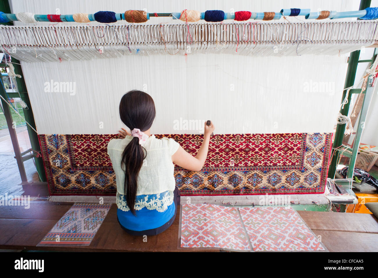 Laos, Vientiane, Magic Lao Carpet Handicrafts, Girl Weaving Carpet