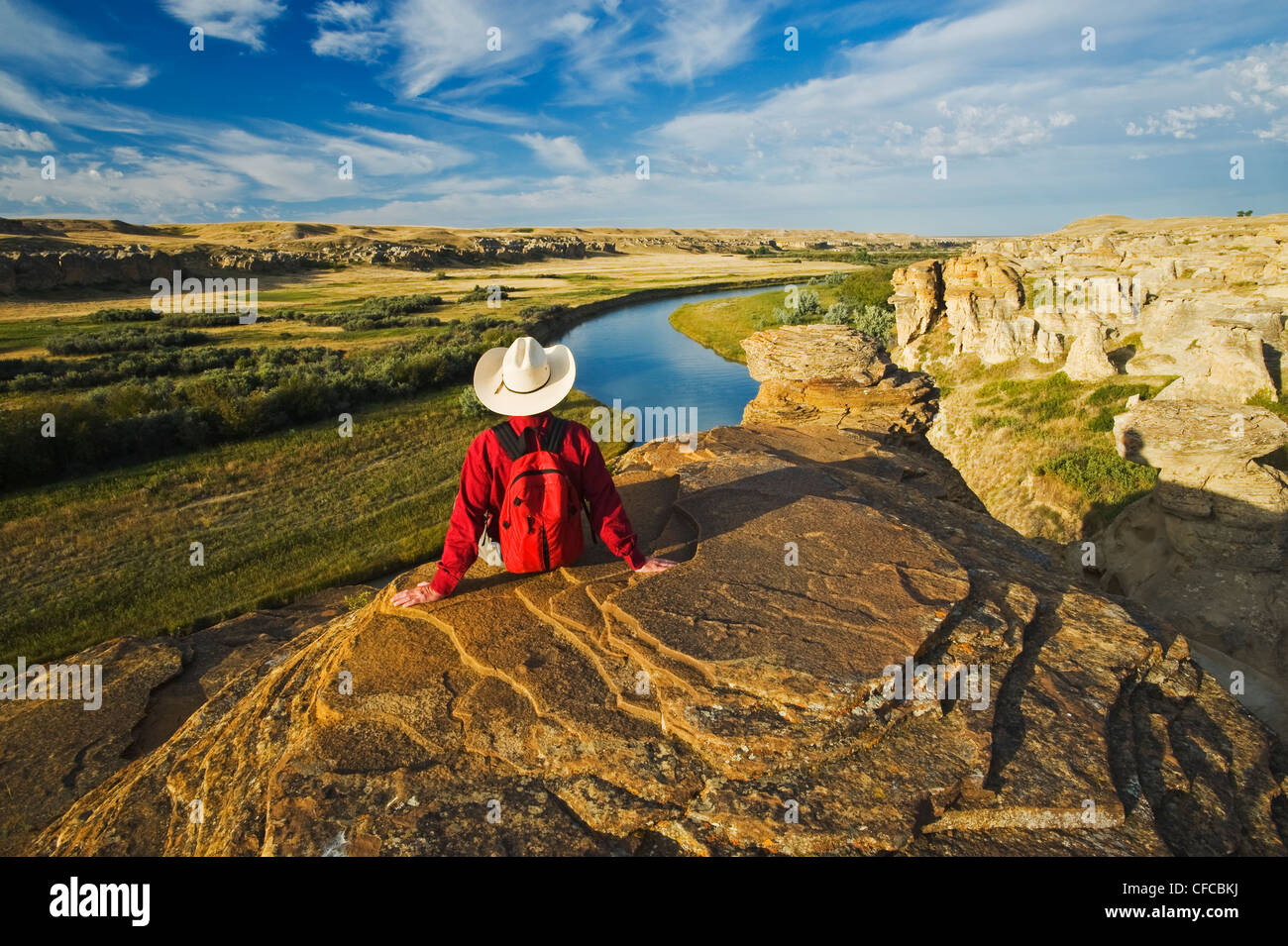 hiker relaxing along the Milk River, Writing On Stone Provincial Park