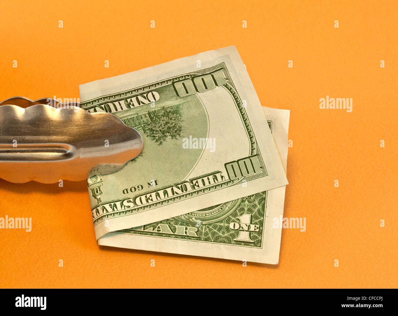 clamp of kitchen with dollars Stock Photo