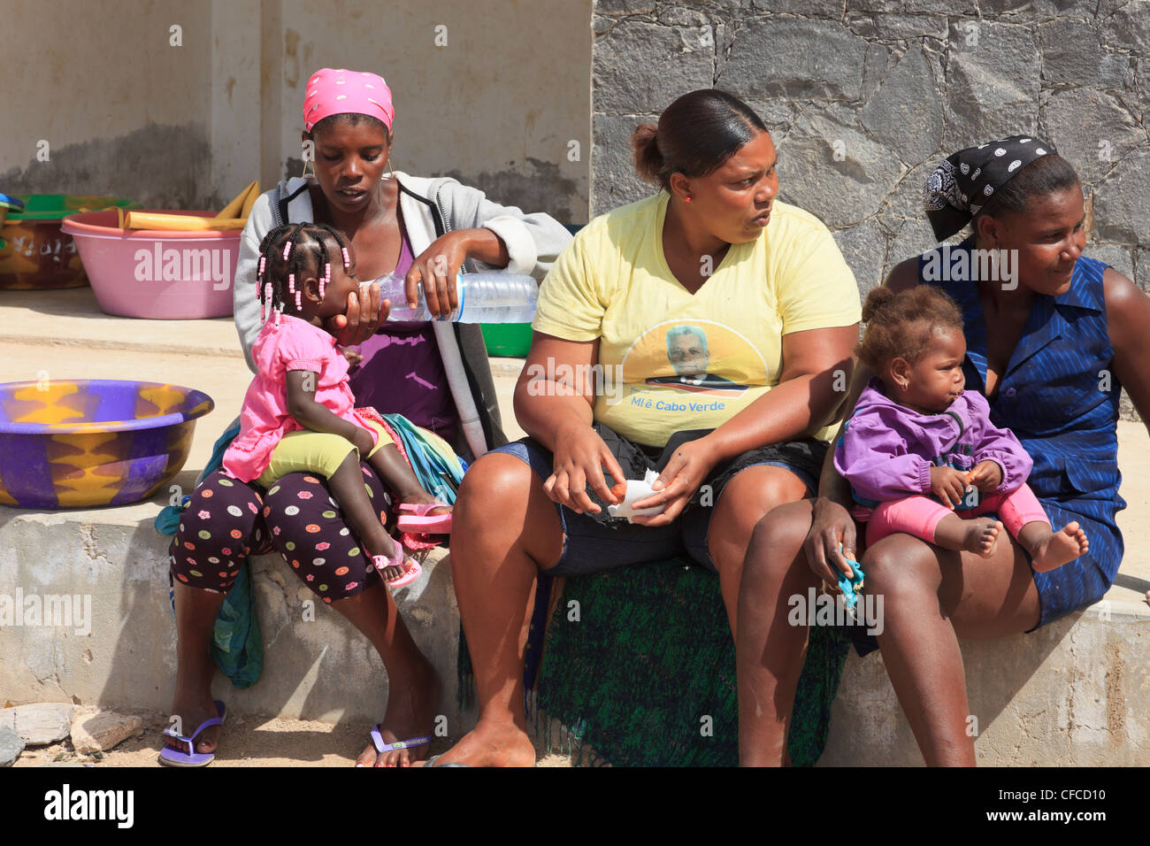 Vaccinere mikroskop Bibliografi Sal Rei Boa Vista Cape Verde Three local women sitting outside with a  mother giving her baby girl a drink of bottled water Stock Photo - Alamy