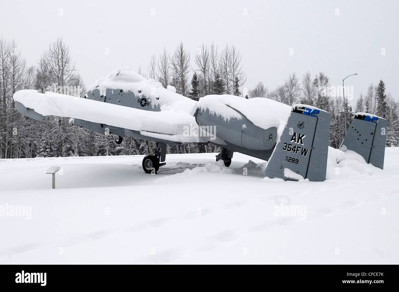 An A-10 Thunderbolt static display at Heritage Park tips backward from the weight of snow on its tail March 6, 2012, Eielson Air Force Base, Alaska. Average snowfall for March usually exceeds 7 inches each year. Stock Photo