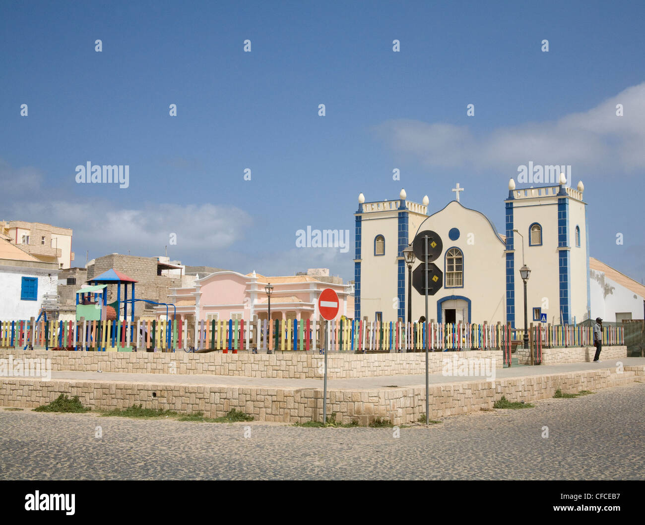 Sal Rei Boa Vista Cape Verde The Childrens' play ground in front of Church of St Isobel in capital city centre man using mobile phone Stock Photo