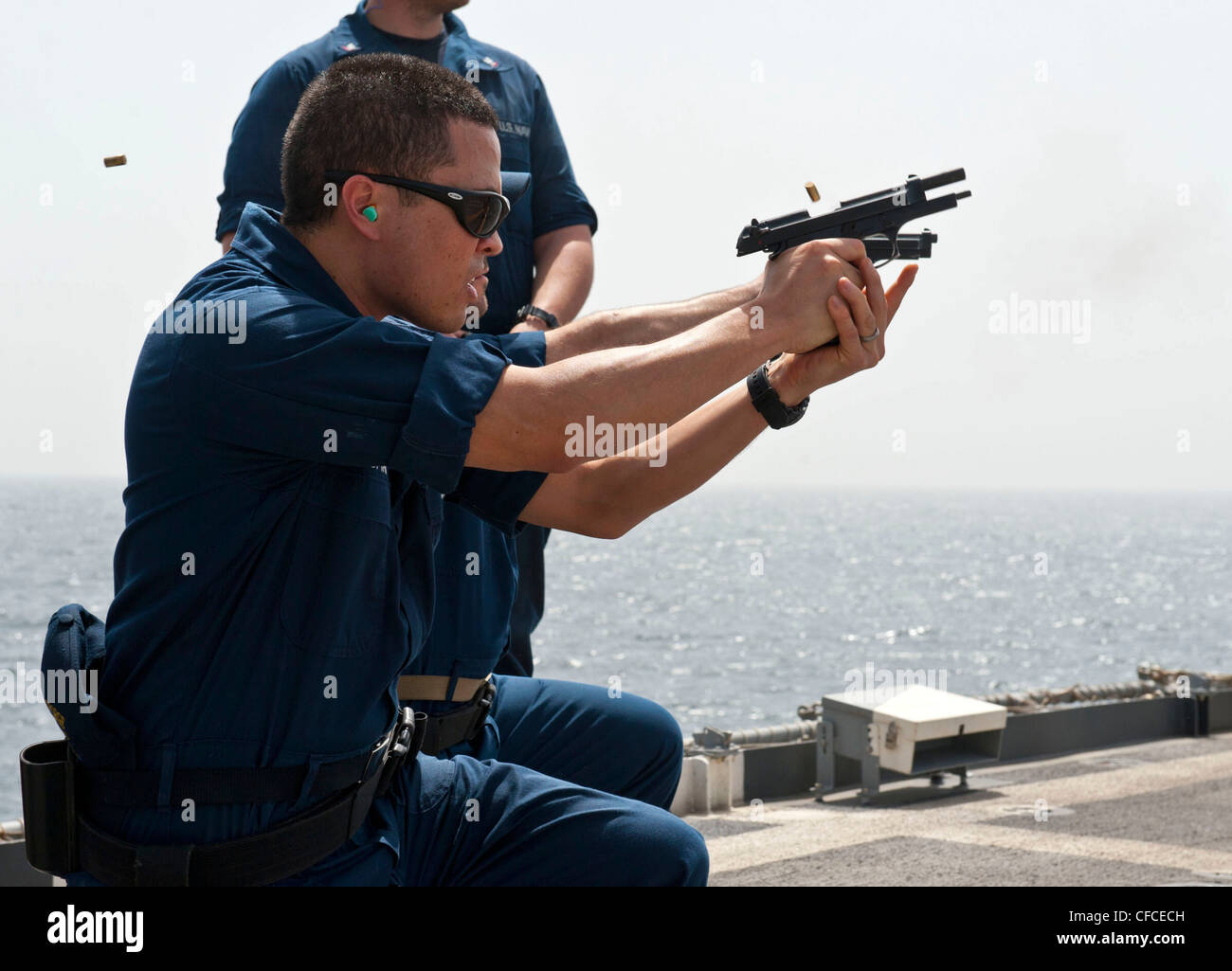 ARABIAN SEA (March 3, 2012) Operations Specialist 2nd Class Andrew Pristyak participates in a 9mm pistol requalification aboard the guided-missile cruiser USS Cape St. George (CG 71). Cape St. George is deployed as part of the Abraham Lincoln Carrier Strike Group to the U.S. 5th Fleet area of responsibility conducting maritime security operations, theater security cooperation efforts and support missions as part of Operation Enduring Freedom. Stock Photo