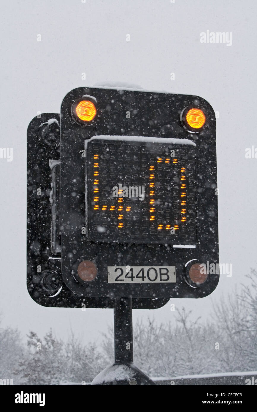 Motorway matrix sign showing recommended 40 mph limit in heavy snow Stock Photo