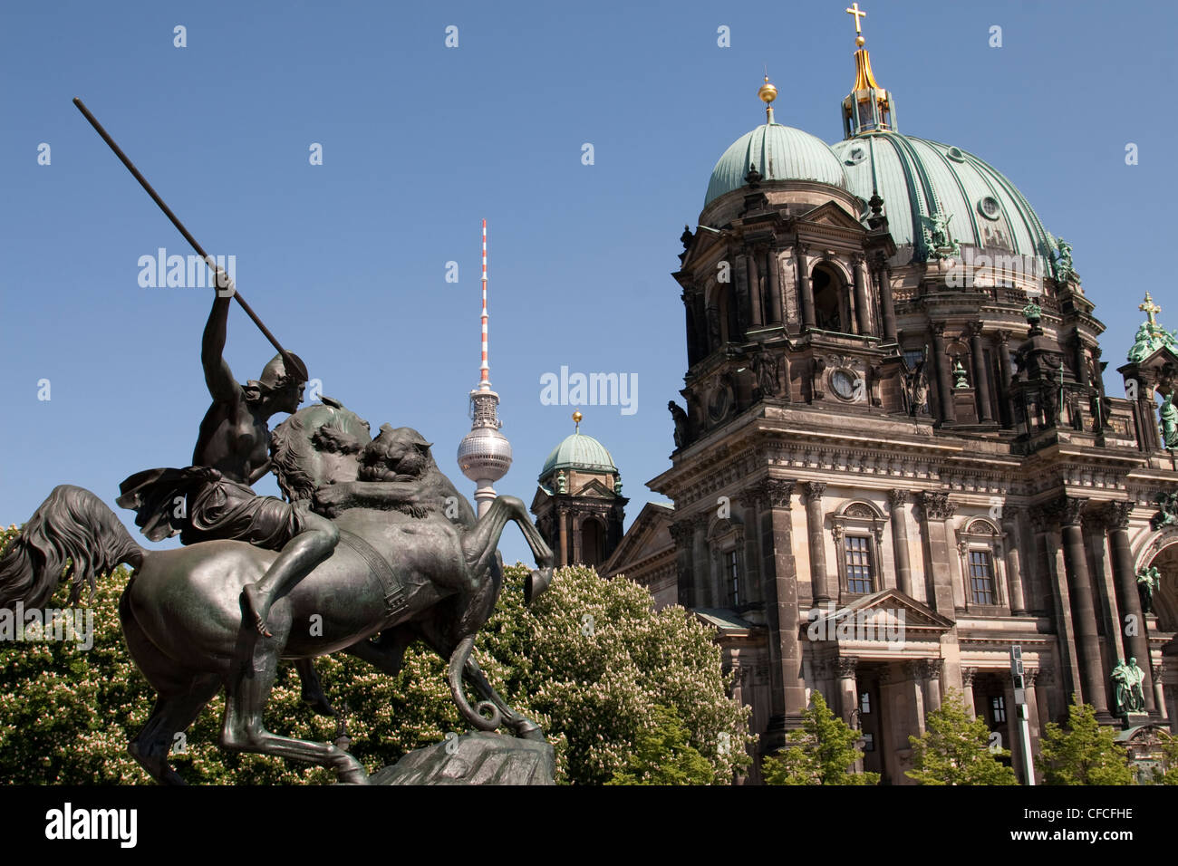 Statue of Amazon on horseback fighting a Lion sculpture in front of the Berlin Cathedral Stock Photo