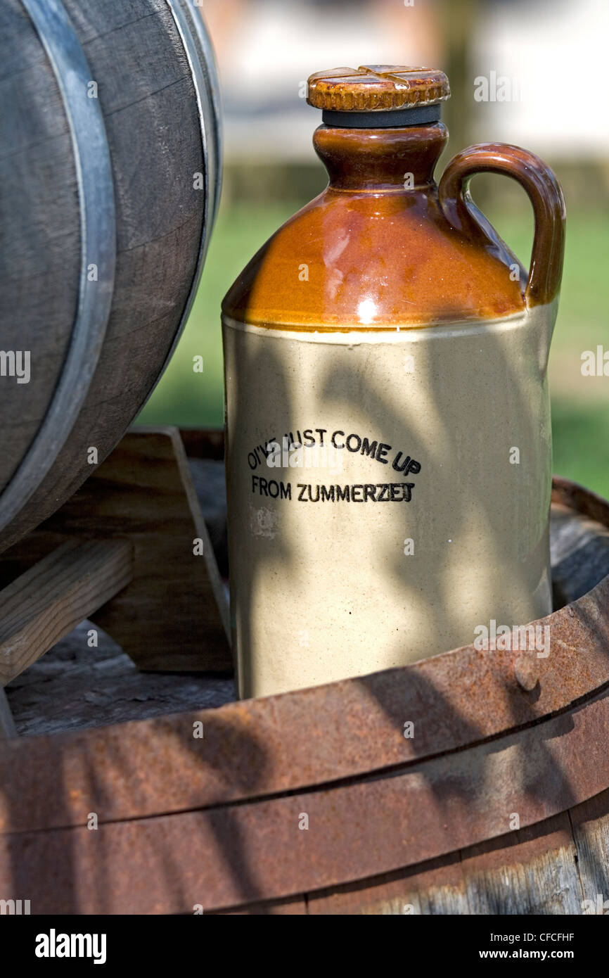 Cider flagon next to barrel Stock Photo Alamy