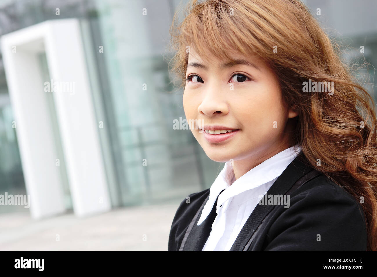 portrait of a young business woman in an office Stock Photo - Alamy