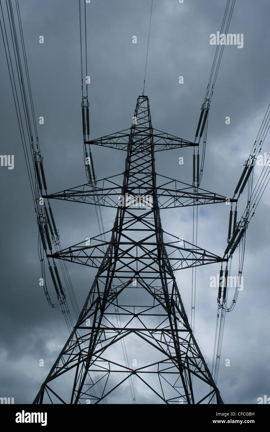 A pylon standing tall with the thunderous sky as a backdrop Stock Photo