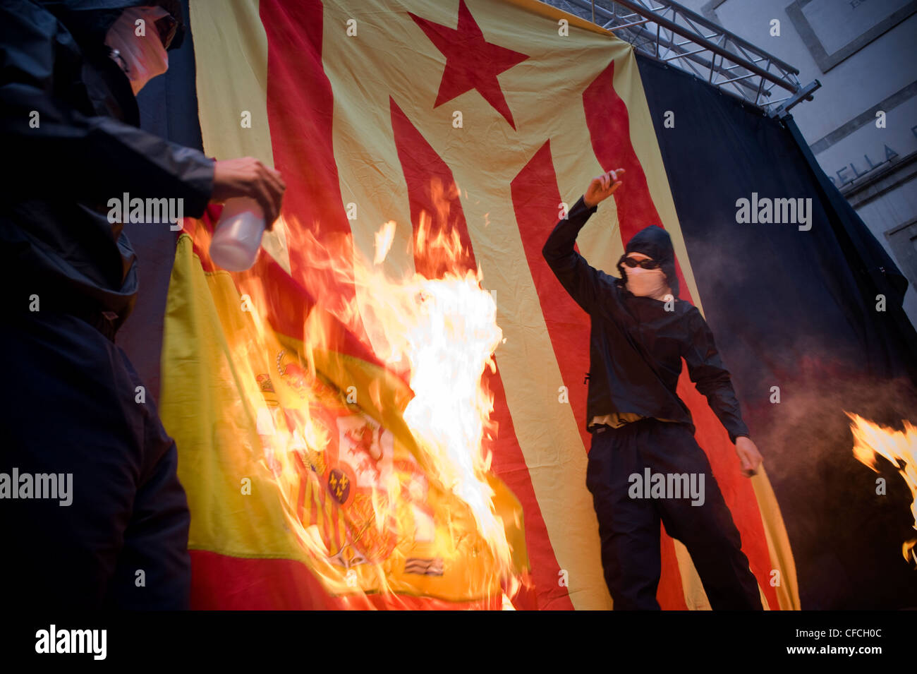 Catalan separatists burn a Spanish flag during the celebrations of National Day of Catalonia in Barcelona, independence day. Stock Photo