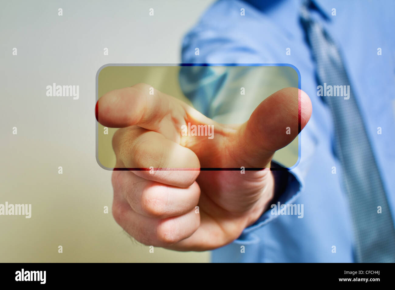Businessman in dark suit is pressing a touchscreen button Stock Photo