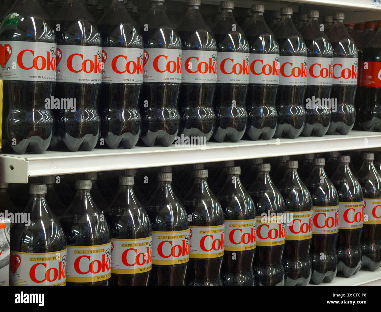 rows of coke soda on grocery store shelves Stock Photo Alamy