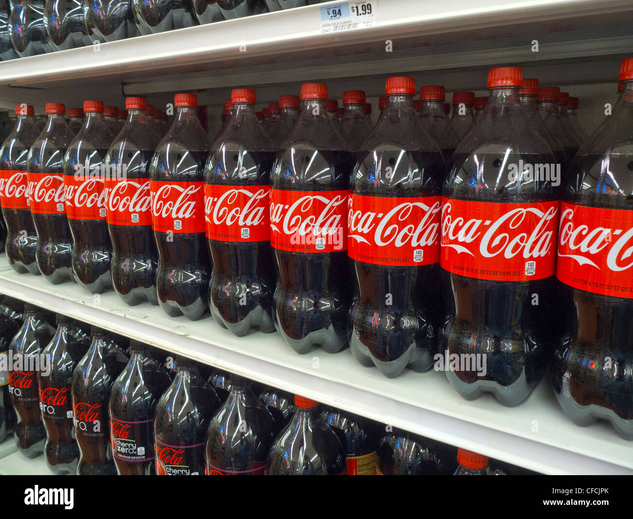 rows of coke soda on grocery store shelves Stock Photo Alamy