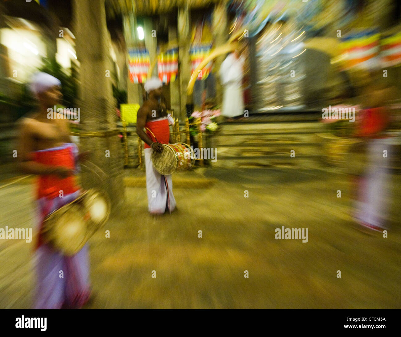 Traditional drummers inside the Sacred Temple of the Tooth Relic (Dalada Maligawa) in Kandy, Sri Lanka ( special blurry effect ) Stock Photo