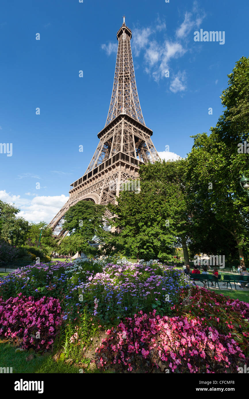 Eiffel tower on a sunny day with flowers in the foreground Stock Photo