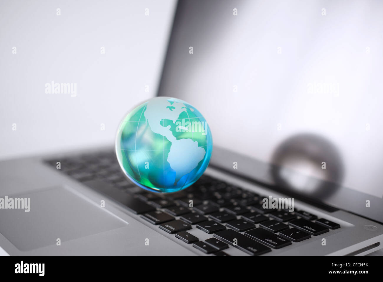 Cristal globe on a Computer Stock Photo - Alamy