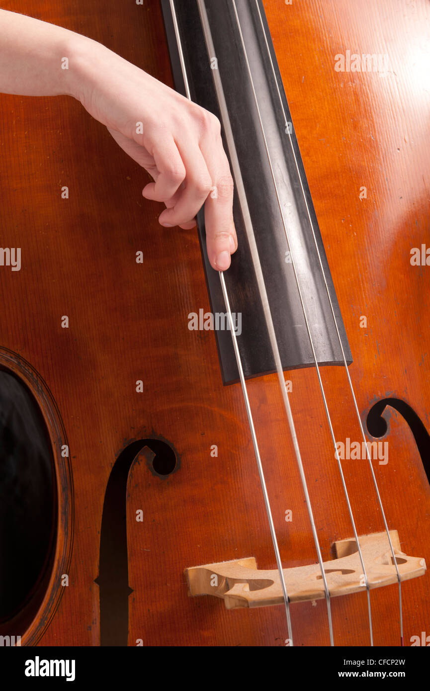 close-up on hand on bass playing pizzicato Stock Photo