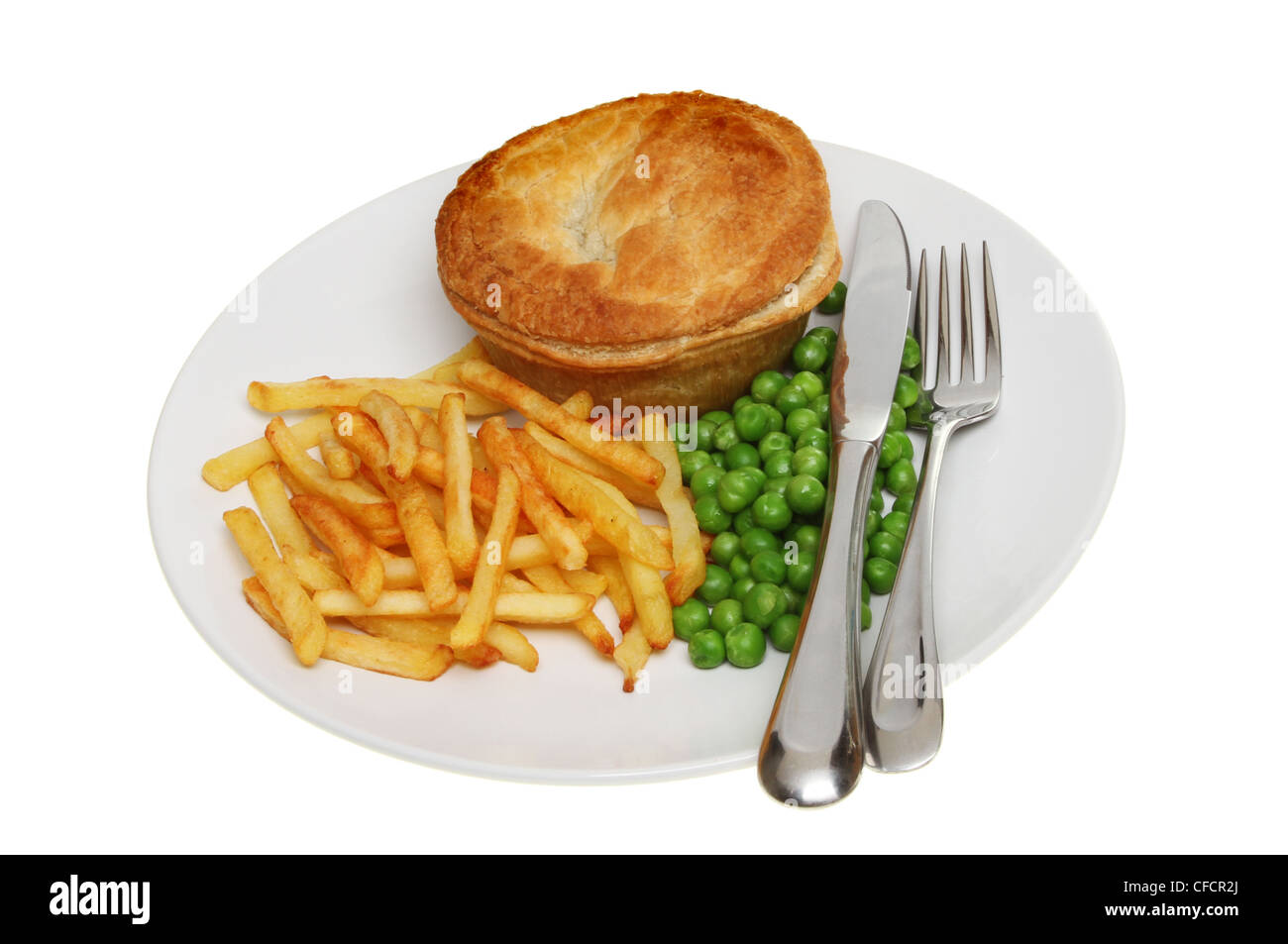 Savory pie potato chips and peas with a knife and fork on a plate isoloated against white Stock Photo