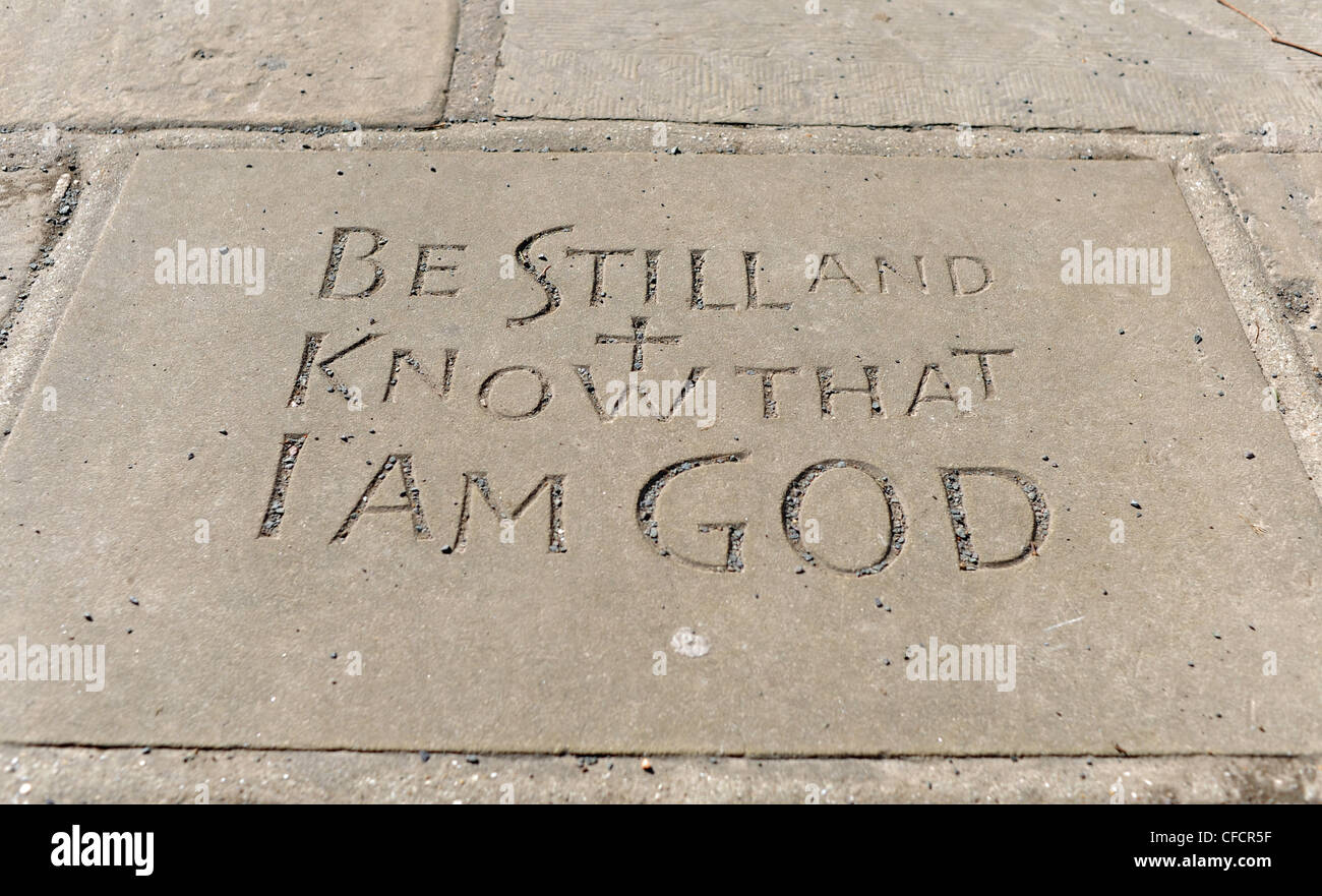Religious reading from Bible on paving slab at St Mary's Church in Horsham West Sussex UK Stock Photo
