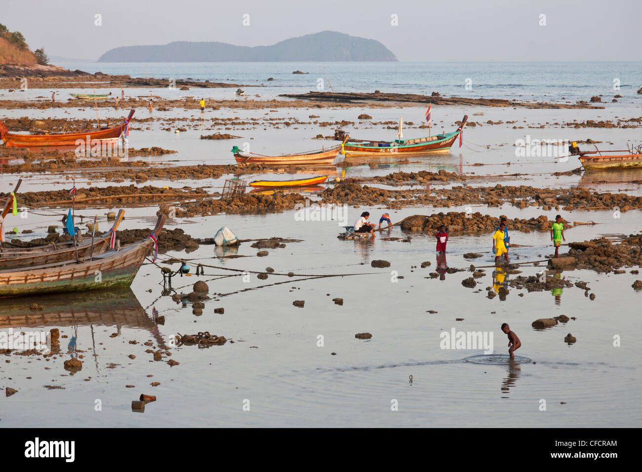 Children playing in the shallow water at low tide, Rawai, Phuket, Thailand, Asia Stock Photo