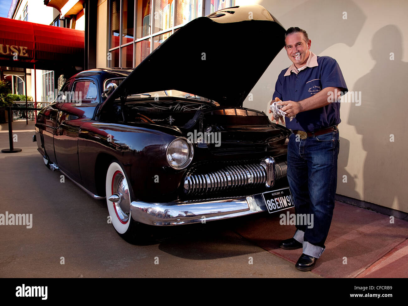 Custom car owner checks oil of 1949 Mercury Sedan/Coupe Custom Stock Photo