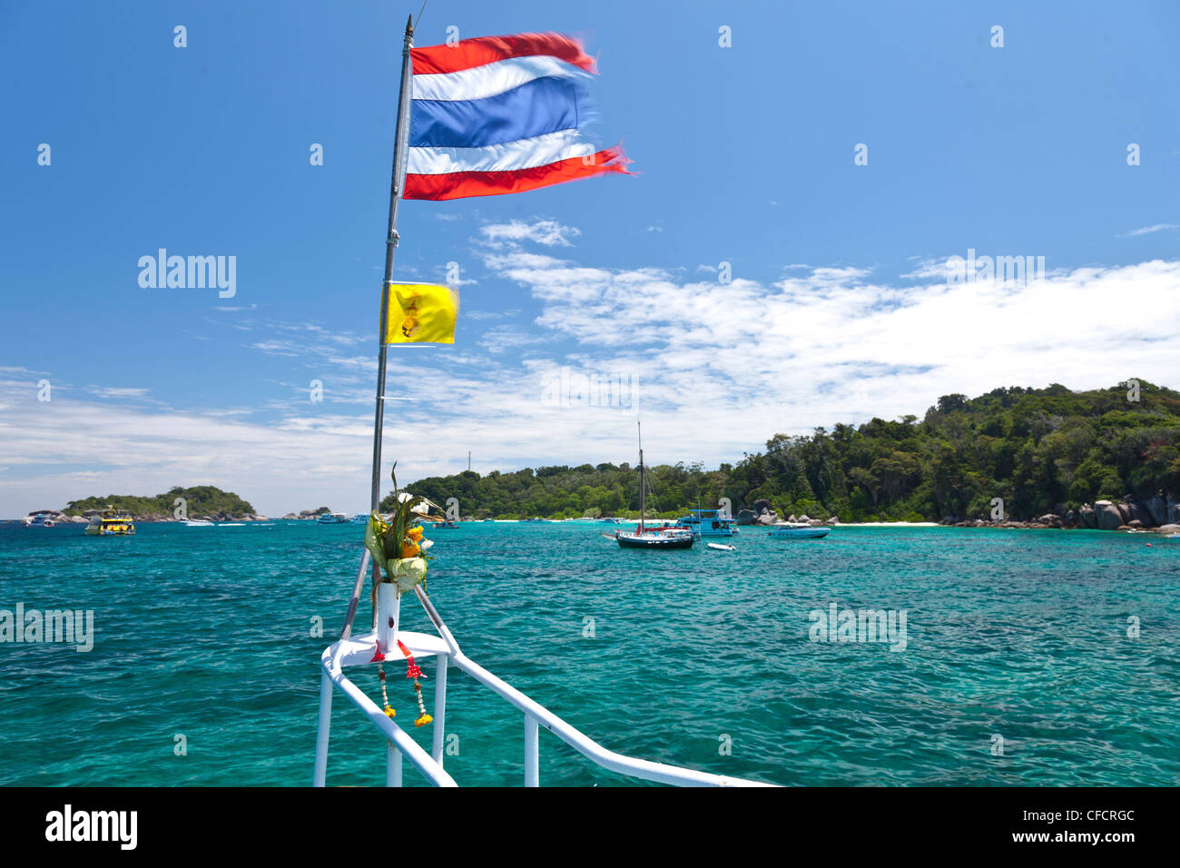 Thai flag in the wind and boats in a bay, Similan Islands, Andaman Sea, Indian Ocean, Khao Lak, Thailand, Asia Stock Photo