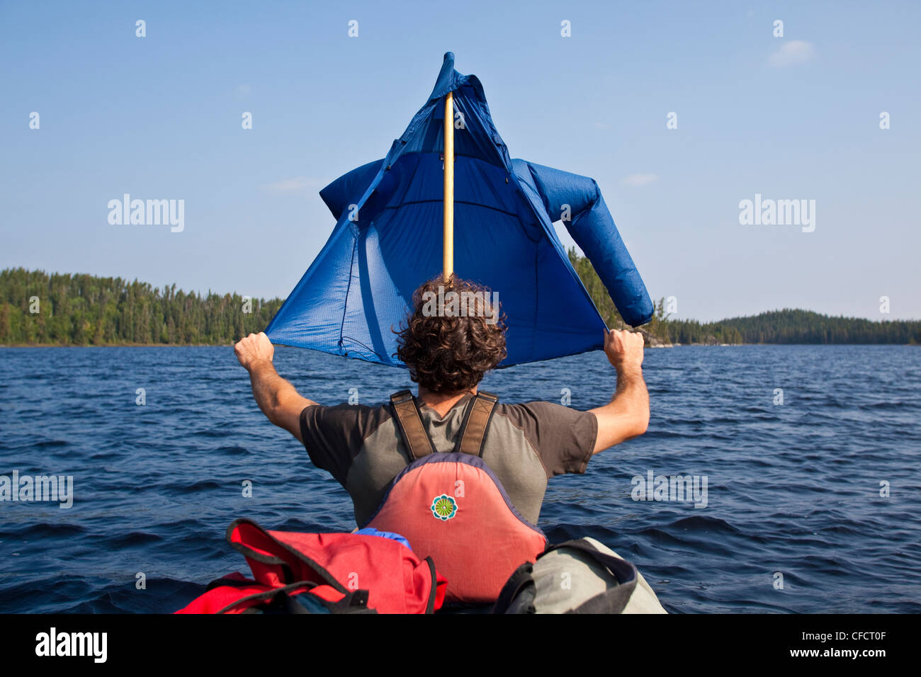 A man tries to sail during a canoe trip in Wabakimi Provincial Park